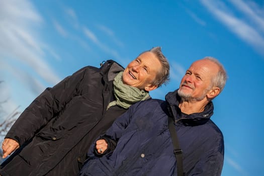 older seniors couple happy laughing in holiday leisure natural ostsee