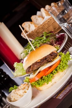 Delicious hamburger cheeseburger with bacon egg and salad on a plate