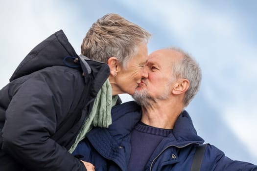 older adult couple seniors happy to take self-portrait photograph with digital camera on vacation