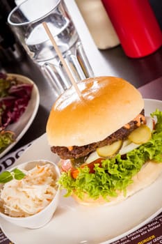 Delicious hamburger cheeseburger with bacon egg and salad on a plate