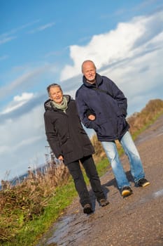 older seniors couple happy laughing in holiday leisure natural ostsee