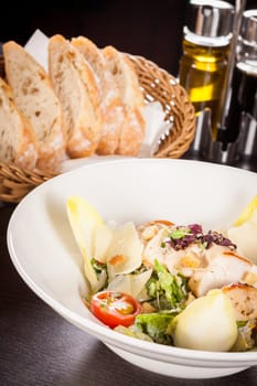 Fresh delicious caesarsalat with grilled chicken bust parmesan splinters and croutons
