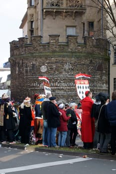 Cologne,Germany – March 02,2014: Colourfully dressed people wearing masks and costumes await the carnival procession on March 2,2014 in Cologne.