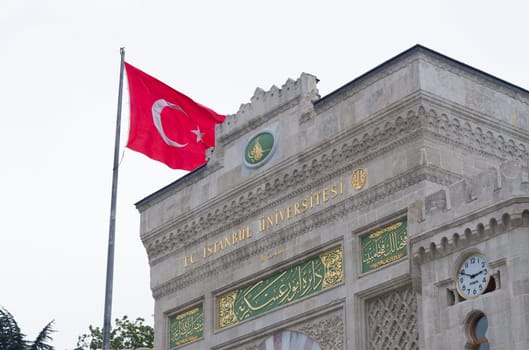 entrance gate of the istanbul university with turkish flag