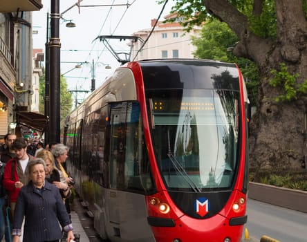 red tram in the streets of istanbul. Istanbul has one modern tramline, which runs from about 5 am until midnight.