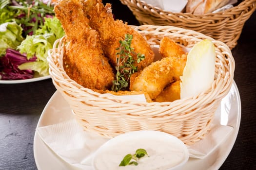 Crispy fried chicken wings with a dip on a plate