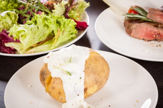 fresh foilpotato from the oven with herb quark sour cream and fresh herbs
