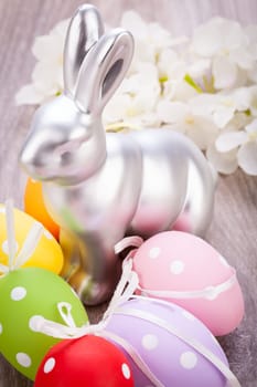 Colourful yellow and red Tulip with Easter eggs decorated at Easter with text space on green background