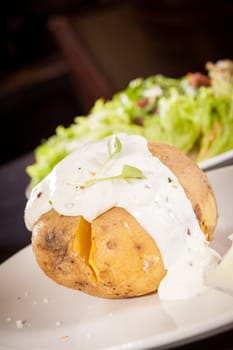 fresh foilpotato from the oven with herb quark sour cream and fresh herbs