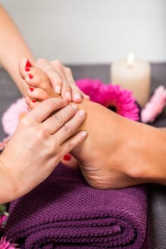 Woman with pedicure in a beauty salon on a towel with lactated toe nails