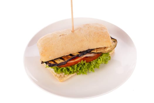 Vegetarian vegan hamburger with aubergine tomato and salad in a ciabatta bun isolated on a white background