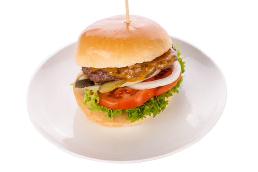 Delicious hamburger cheeseburger with bacon egg and salad on a plate isolated on a white background