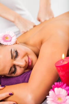 young woman relaxes during a back massage at salon wellness spa health therapy