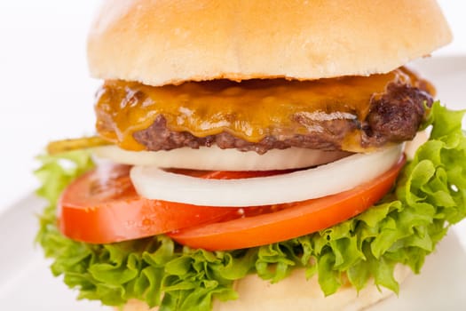 Delicious hamburger cheeseburger with bacon egg and salad on a plate isolated on a white background