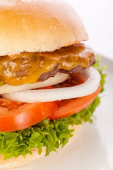 Delicious hamburger cheeseburger with bacon egg and salad on a plate isolated on a white background
