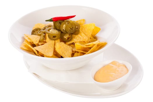 Bowl with nachos tortillas with pepperoni and fresh tomato salsa in a plate insulated against a white background