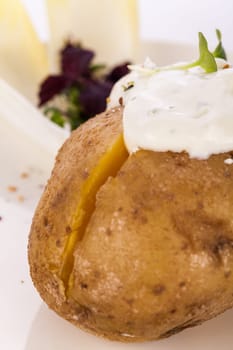 fresh foilpotato from the oven with herb quark sour cream and fresh herbs