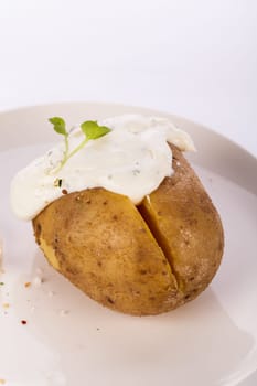 fresh foilpotato from the oven with herb quark sour cream and fresh herbs