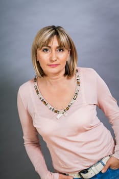 adult attractive woman in middle age portrait against gauem background