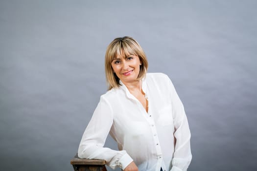 adult attractive woman in middle age portrait against gauem background