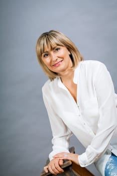 adult attractive woman in middle age portrait against gauem background