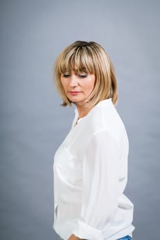 adult attractive woman in middle age portrait against gauem background