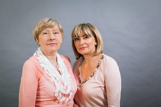 older adult happy wife mother with adult daughter portrait generation against grey background