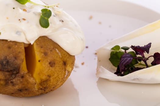 fresh foilpotato from the oven with herb quark sour cream and fresh herbs