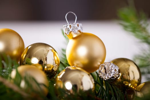 Golden shiny Christmas tree decoration Advebtsschmuck on green fir branches as close-up