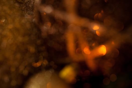 Warm golden and orange Christmas decoration with candlelight as close-up in context