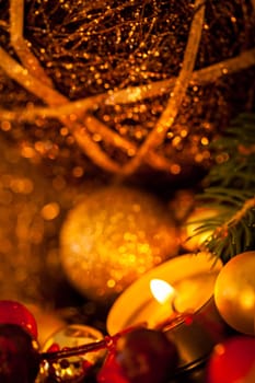 Warm golden and orange Christmas decoration with candlelight as close-up in context