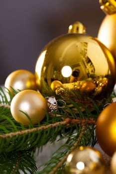 Golden shiny Christmas tree decoration Advebtsschmuck on green fir branches as close-up