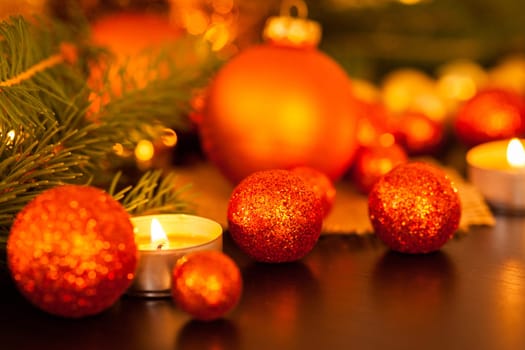 Warm golden and orange Christmas decoration with candlelight as close-up in context