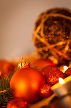 Warm golden and orange Christmas decoration with candlelight as close-up in context