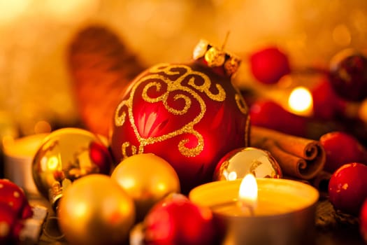 Warm golden and orange Christmas decoration with candlelight as close-up in context