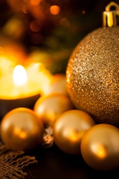 Warm golden and orange Christmas decoration with candlelight as close-up in context