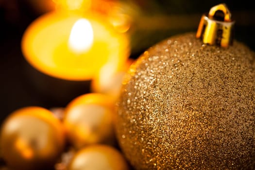 Warm golden and orange Christmas decoration with candlelight as close-up in context