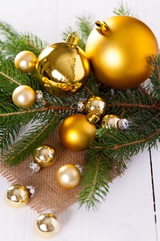 Golden shiny Christmas tree decoration Advebtsschmuck on green fir branches as close-up
