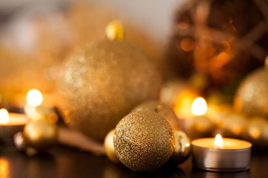 Warm golden and orange Christmas decoration with candlelight as close-up in context
