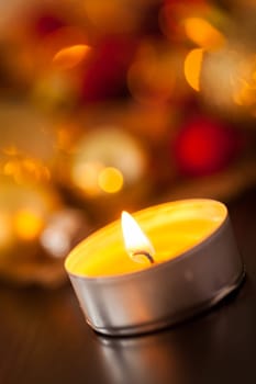 Warm golden and orange Christmas decoration with candlelight as close-up in context