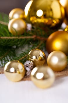Golden shiny Christmas tree decoration Advebtsschmuck on green fir branches as close-up