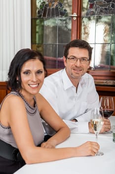 Young couple group in a restaurant cheerful while drinking