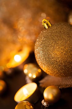 Warm golden and orange Christmas decoration with candlelight as close-up in context