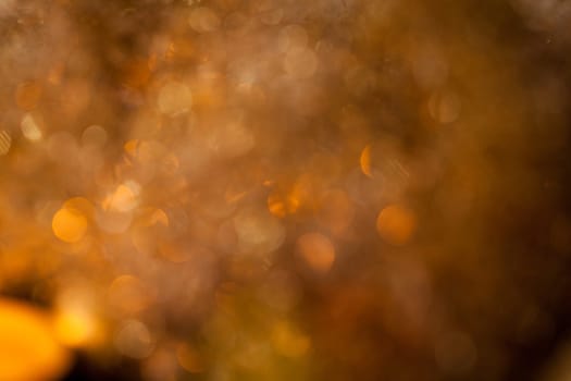 Warm golden and orange Christmas decoration with candlelight as close-up in context