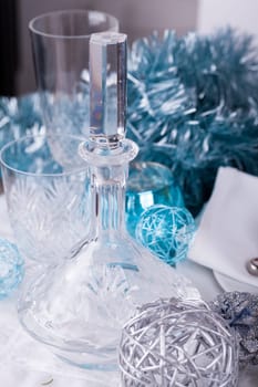 Stylish table with Christmas decoration in turquoise and silver shiny with cutlery