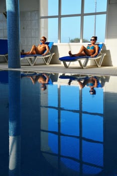 Two young women at the swimming pool.