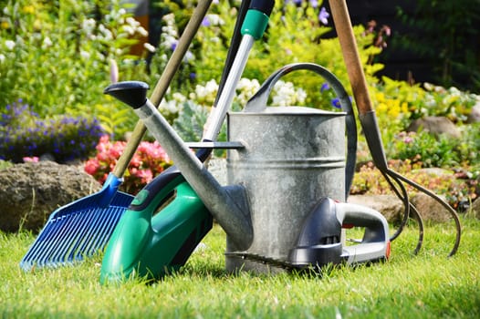 Watering can and tools in the garden