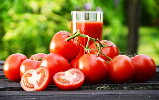 Tomatoes and juice in the garden. Organic food.