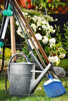 Watering can and tools in the garden