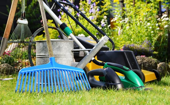 Watering can and tools in the garden